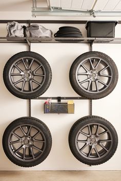 four wheels are hanging on the wall and there is no image here to provide a caption for