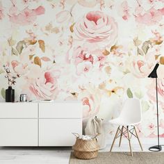 a white dresser sitting next to a wall covered in pink flowers