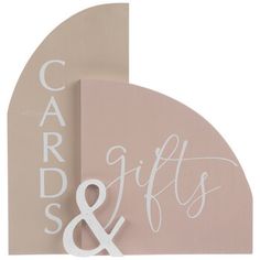 a wooden sign with the words cards and gifts on it next to a pink wall