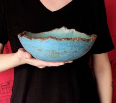 a woman holding a blue bowl in her hands