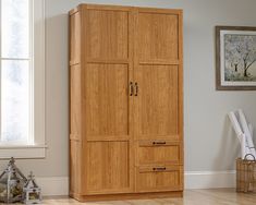 a wooden armoire with two drawers in a room