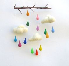 there is a mobile made out of felt and rain drops