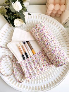 Our floral quilted makeup brush roll is handmade in Melbourne in a cotton fabric. It offers style and keeps your makeup brushes protected during travel.  Featuring 12 spacious pockets and a long tie to help secure your brushes in place. It is perfect for travel and everyday use. Dimensions of product lay flat  20cm height x 37cm width, tie 64cm long Care instructions Hand wash recommended or machine cold wash on gentle cycle in wash bag Makeup Brush Roll, Floral Makeup, Makeup Brush Holder, Brush Roll, Makeup Brush Holders, Toiletry Storage, Design Floral, Wash Bags, Makeup Brush