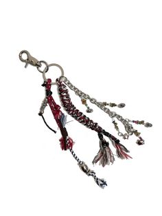 a key chain with beads and tassels hanging from it's side on a white background