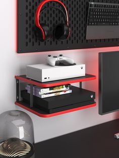 a computer desk with a monitor, keyboard and headphones on the shelf above it