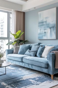 a living room filled with furniture and a large painting hanging on the wall above it