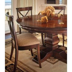 a dining room table with two chairs and a stuffed animal on top of the table