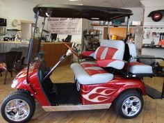 a red and white golf cart in a shop