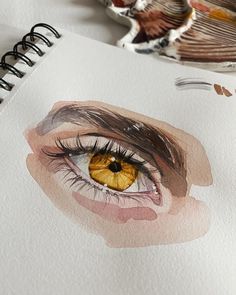 a drawing of a woman's eye with watercolor and pencils on paper