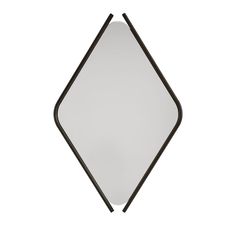 a black and white mirror sitting on top of a wall