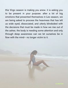 a woman sitting on top of a beach next to the ocean