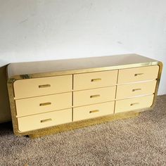 a yellow dresser sitting on top of a carpeted floor