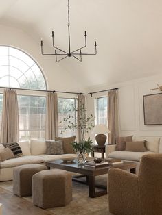 a living room filled with furniture and windows