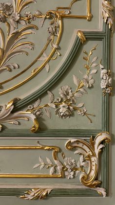 an ornate gold and green panel with flowers on it