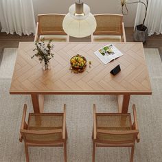 an overhead view of a dining room table with chairs