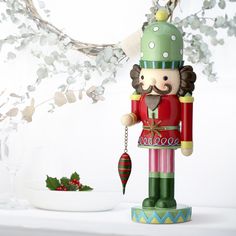 a nutcracker figurine next to a christmas decoration