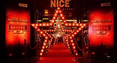 a red carpeted hallway with lighted stars and welcome signs