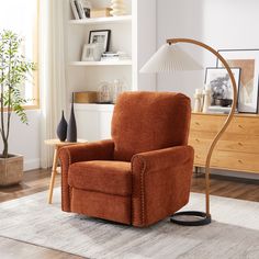 a living room with a chair, lamp and bookshelf