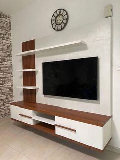 a large flat screen tv mounted to the side of a wall in a living room