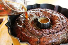 a bundt cake is being drizzled with syrup