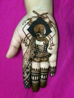 a person's hand painted with hennap and designs on the top of it