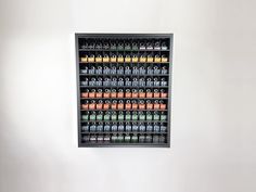 a wall mounted display case filled with lots of bottles