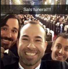 three men in tuxedos are smiling at the camera with an audience behind them