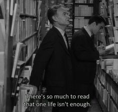 two men in suits are looking at books on shelves with the words they say they have no concerns