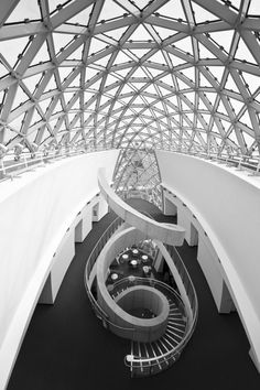 the inside of a building with lots of glass and metal structures on it's walls