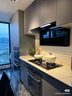 a kitchen with a stove top oven next to a window