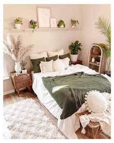 a bedroom with white and green decor on the walls, bedding, rugs and plants