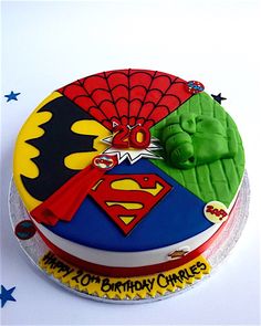 the birthday cake is decorated with an image of superman and green man's head