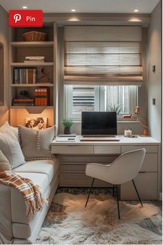 a room with a couch, desk and computer on the corner in front of a window