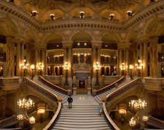 an ornate building with many stairs and chandeliers