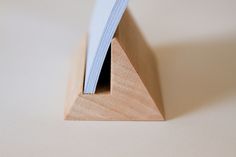 a close up of a wooden object on a white surface with a blue strip sticking out of it