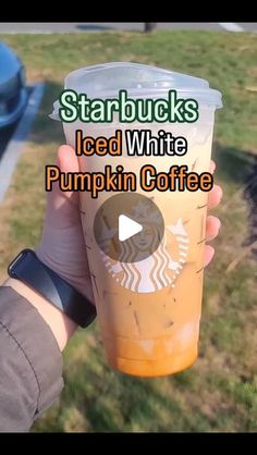 someone holding up a starbucks cup with the words starbucks's iced white pumpkin coffee