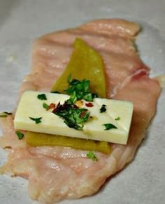 raw fish fillets with cheese and herbs on them