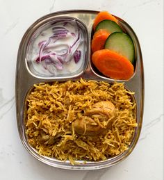 a metal tray filled with different types of food on top of a white countertop