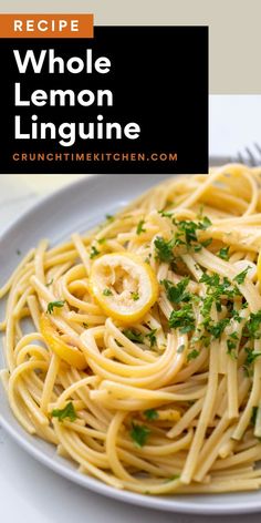 a white plate topped with spaghetti and lemons