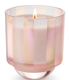 a pink glass candle holder with a lit candle in it