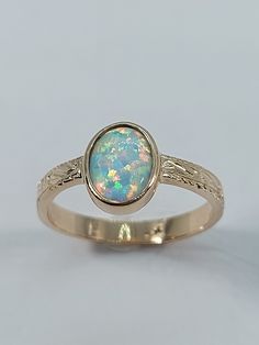 This stunning opal ring has been carefully crafted in 10k Yellow Gold and Lab Opal . Great for any occasion! Buy it for your-self or for someone you love! This beautiful ring will not go unnoticed. All of my jewelry is handmade from scratch and of high quality.  Ring Weight: 2.5 grams Stone Measurements: Lab Opal  6.0 mm x 8.0 mm Ring Band Size: 2.64 mm at smallest point, 9.0 mm at widest point Materials: 10k Yellow Gold, Lab Opal  Please let me know if you any questions Thanks for visiting my s Luxury Moonstone Opal Ring For Gift, Luxury Gold Opal Ring With Moonstone, Luxury Natural Stone Opal Ring As Gift, Luxury Polished Finish Opal Ring For Formal Occasions, Luxury Heirloom Opal Ring Gift, Luxury Antique Opal Ring As A Gift, Luxury Antique Opal Ring As Gift, Luxury Antique Opal Ring For Gift, Luxury Natural Stone Opal Ring Gift