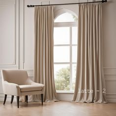 a chair sitting in front of a window next to a white wall and wooden floor