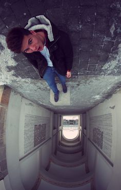 a woman is standing in the middle of a tunnel with her feet up and looking at the camera