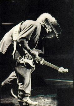 a man playing an electric guitar on stage