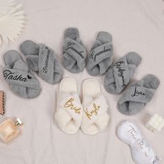 several personalized slippers are laid out on a bed