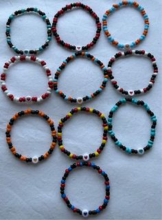 six bracelets with different colored beads on them