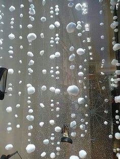 the window is covered with white balls and snowflakes