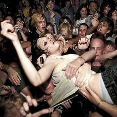 a group of people standing around each other at a concert