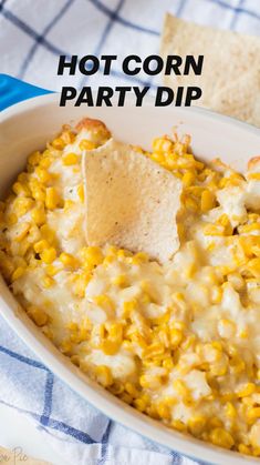 a white bowl filled with corn and tortilla chips next to a blue towel