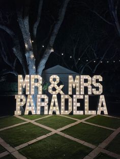 the words mr and mrs paradela are lit up in front of a tree